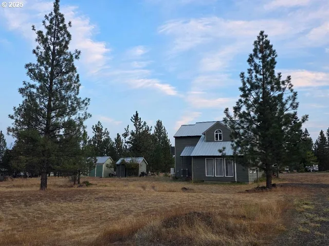 a view of house with outdoor space and garden