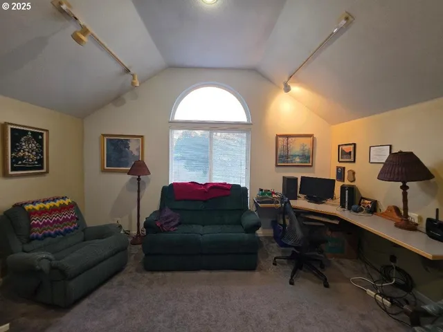 a view of a livingroom with furniture and staircase