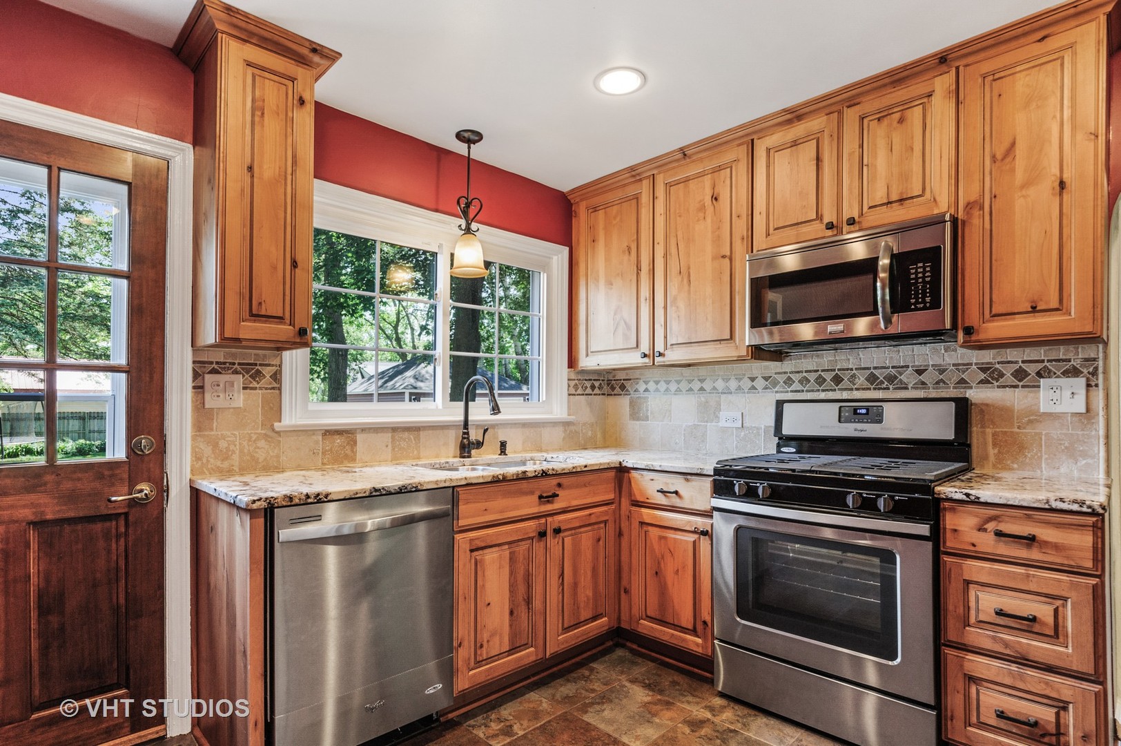 275 Harding Street Grayslake, IL 60030 - Photo 4 of 27 a kitchen with stainless steel appliances granite countertop a stove microwave and sink