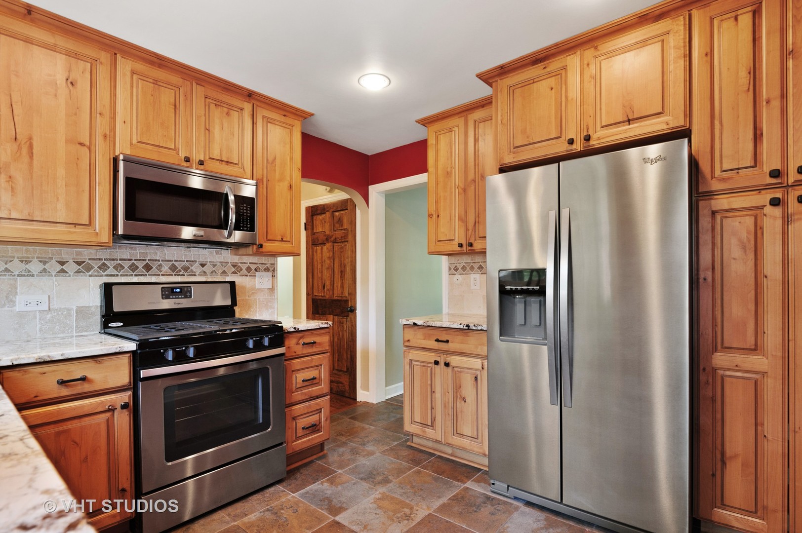 275 Harding Street Grayslake, IL 60030 - Photo 5 of 27 a kitchen with granite countertop a refrigerator stove and microwave