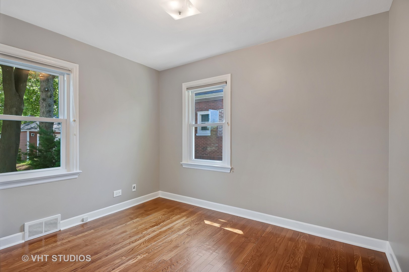 275 Harding Street Grayslake, IL 60030 - Photo 7 of 27 a view of an empty room with wooden floor and a window