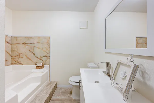 a bathroom with a bathtub and sink