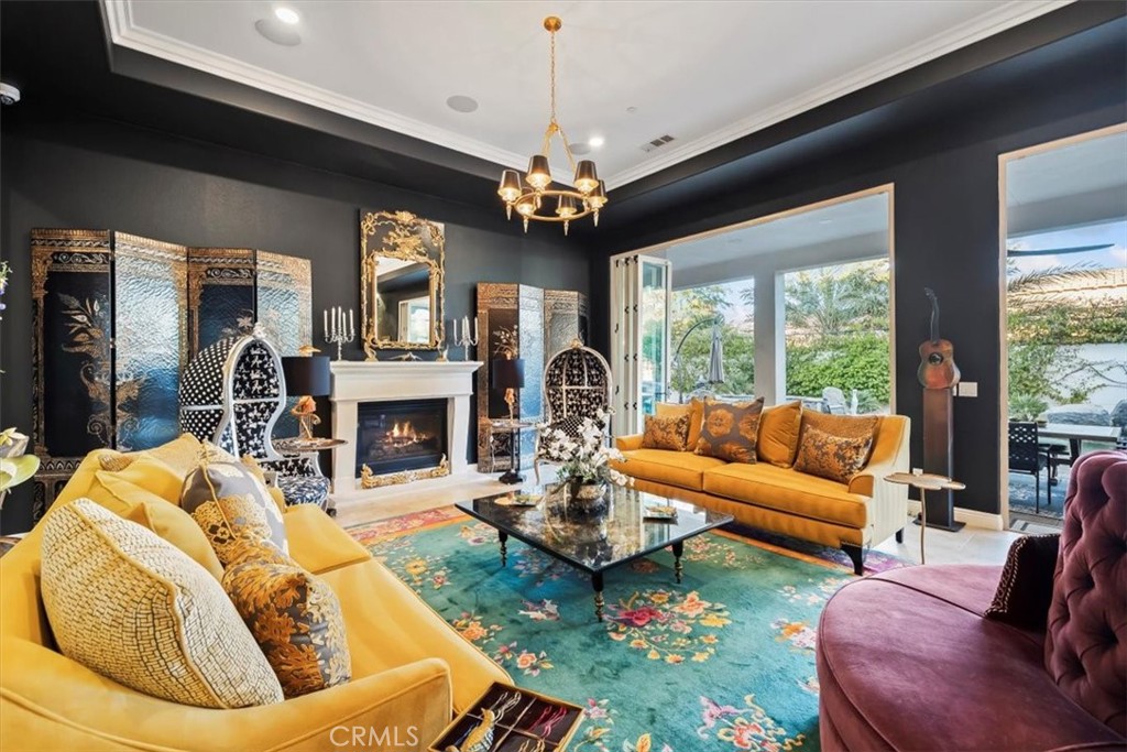 81094 Monarchos Circle La Quinta, CA 92253 - Photo 11 of 75 a living room with furniture a chandelier and a fireplace