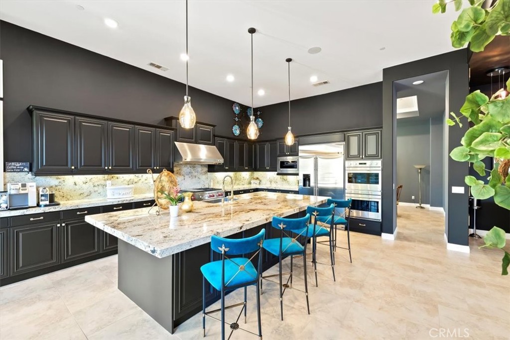 81094 Monarchos Circle La Quinta, CA 92253 - Photo 19 of 75 a kitchen with lots of counter top space and living room view