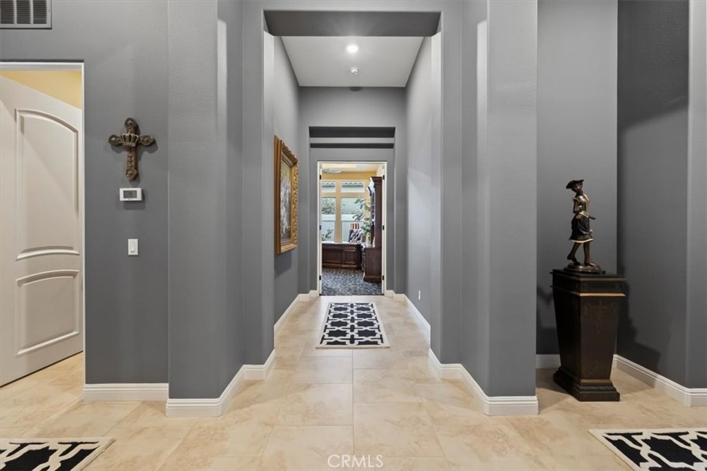 81094 Monarchos Circle La Quinta, CA 92253 - Photo 27 of 75 a bedroom with a bed and a chandelier