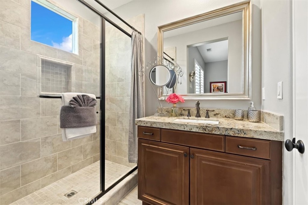 81094 Monarchos Circle La Quinta, CA 92253 - Photo 34 of 75 a bathroom with a granite countertop shower sink and mirror