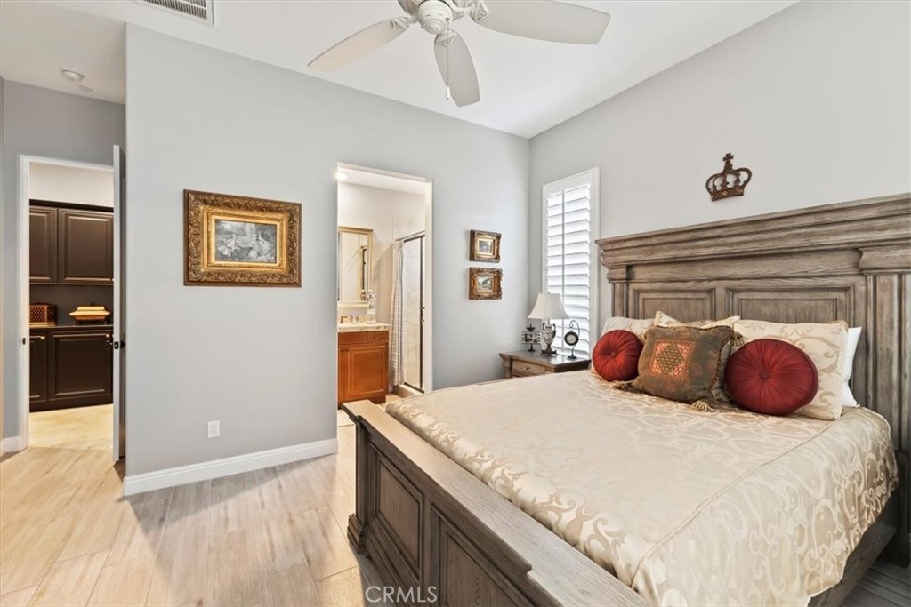 81094 Monarchos Circle La Quinta, CA 92253 - Photo 41 of 75 a bedroom with a large bed and a chandelier