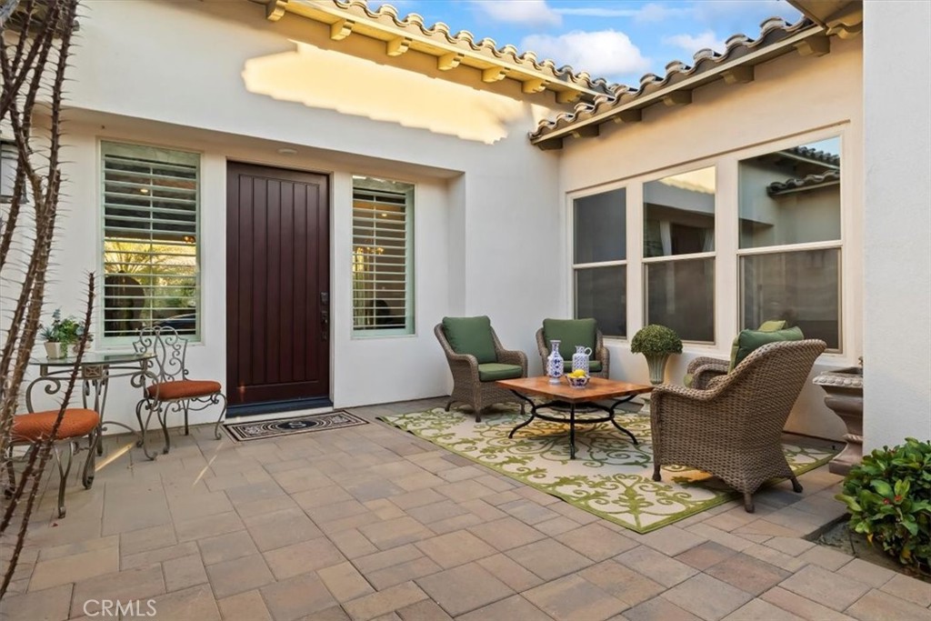 81094 Monarchos Circle La Quinta, CA 92253 - Photo 7 of 75 a view of a patio with couple of chairs and a potted plant