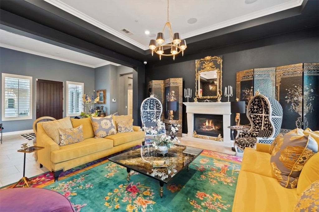 81094 Monarchos Circle La Quinta, CA 92253 - Photo 8 of 75 a living room with furniture a fireplace and a chandelier