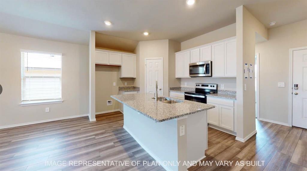 10312 Neptune Court Waco, TX 76708 - Photo 2 of 9 a kitchen with kitchen island a sink counter top space a refrigerator and a stove top oven