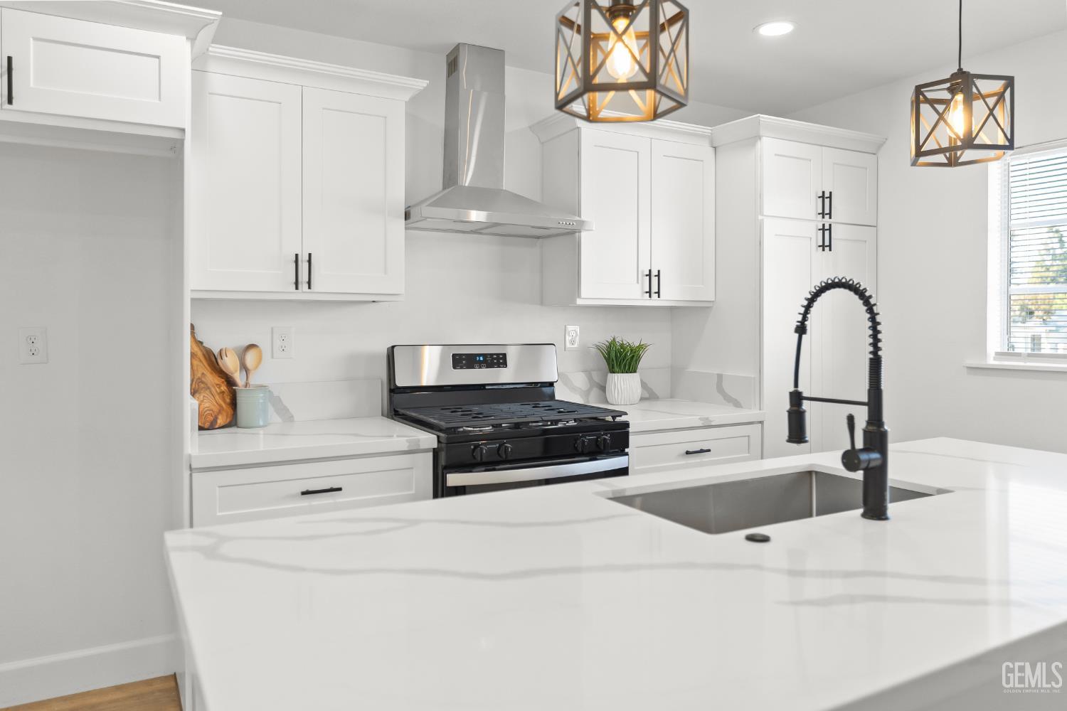 Undisclosed Address Tehachapi, CA 93561 - Photo 16 of 49 a kitchen with granite countertop white cabinets and a sink