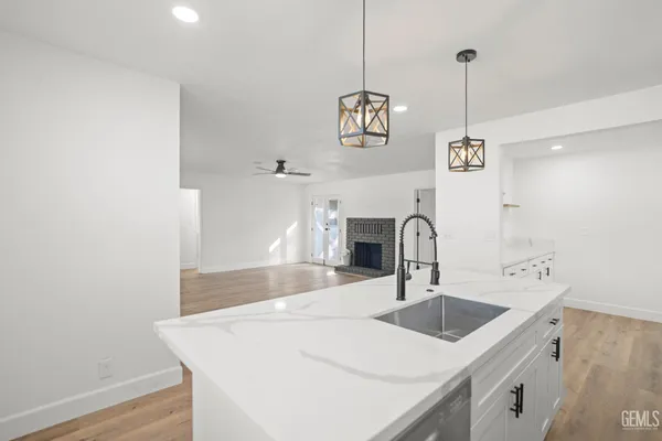 a kitchen with a sink a counter space and stainless steel appliances