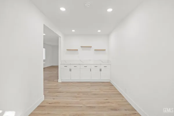 an empty room with wooden floor