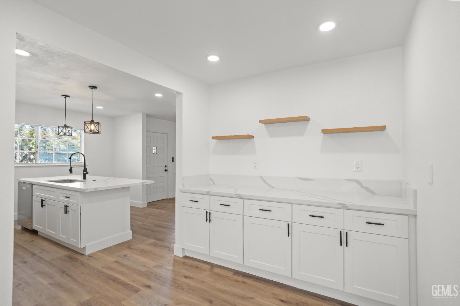 Undisclosed Address Tehachapi, CA 93561 - Photo 23 of 49 a large white kitchen with a white cabinets and sink