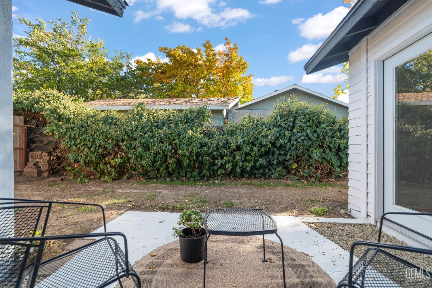 Undisclosed Address Tehachapi, CA 93561 - Photo 40 of 49 a backyard of a house with table and chairs