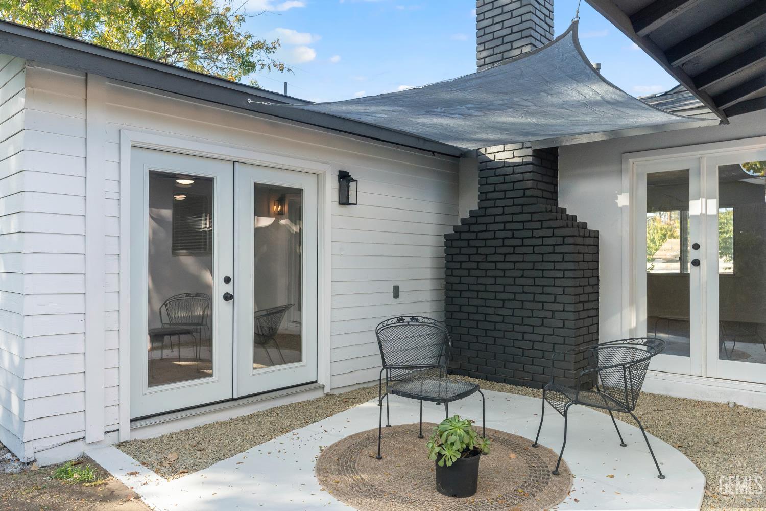 Undisclosed Address Tehachapi, CA 93561 - Photo 42 of 49 a patio with a table and chairs and potted plants