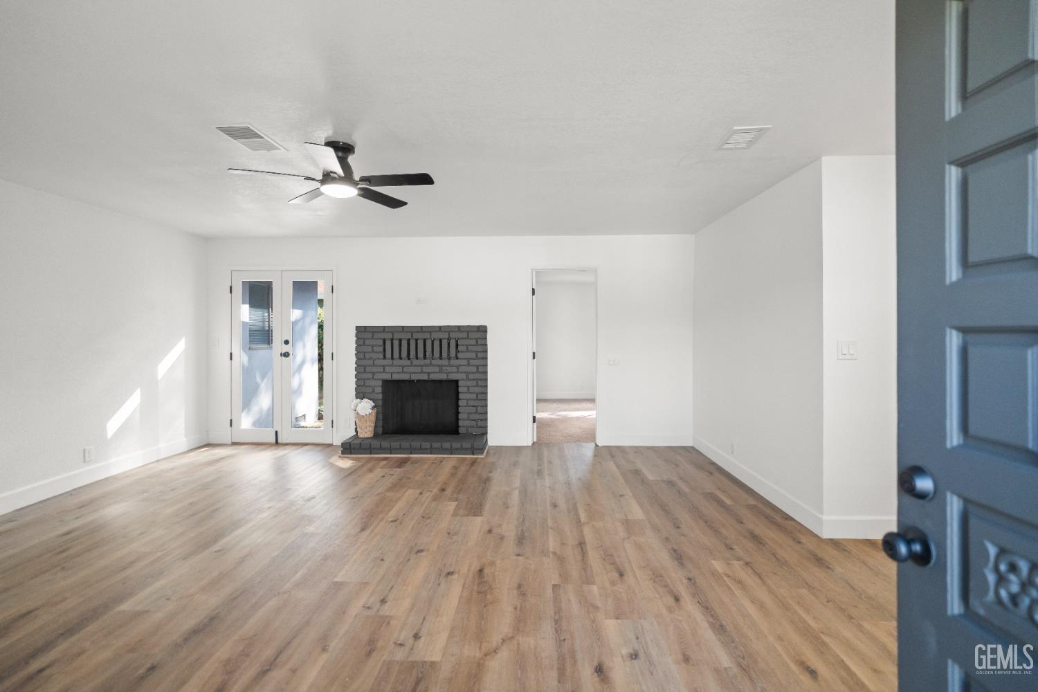 Undisclosed Address Tehachapi, CA 93561 - Photo 9 of 49 a view of empty room with wooden floor and fireplace