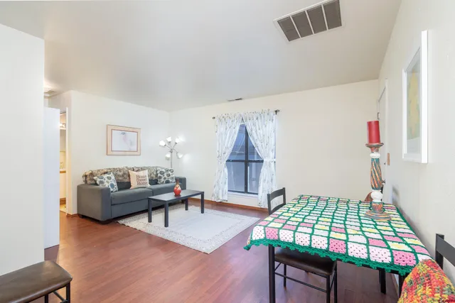 a living room with furniture and wooden floor