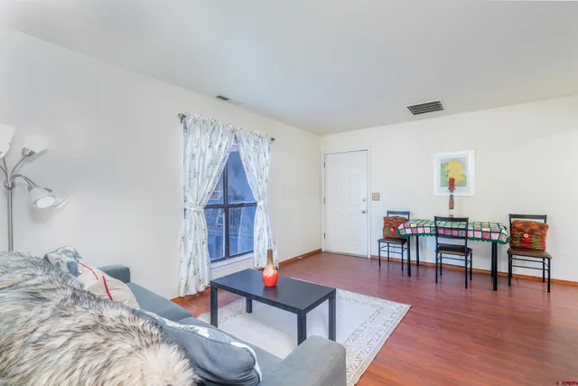 a bedroom with furniture and a wooden floor