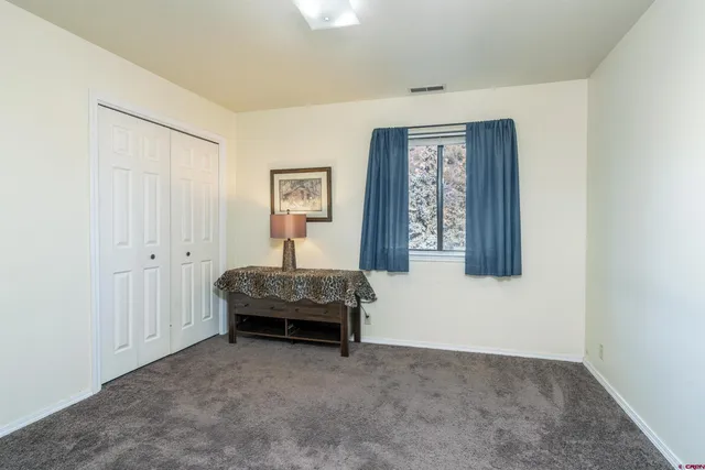a spacious bedroom with a bed and a window