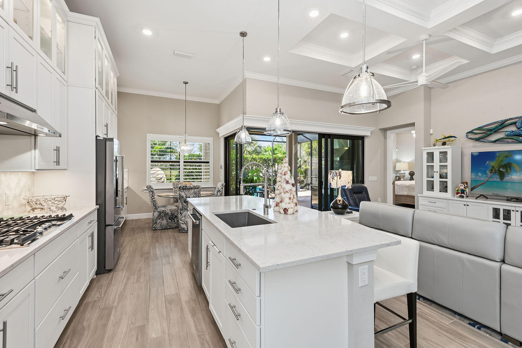 2797 Amaranda Court Naples, FL 34114 - Photo 11 of 50 a large white kitchen with a large window and stainless steel appliances