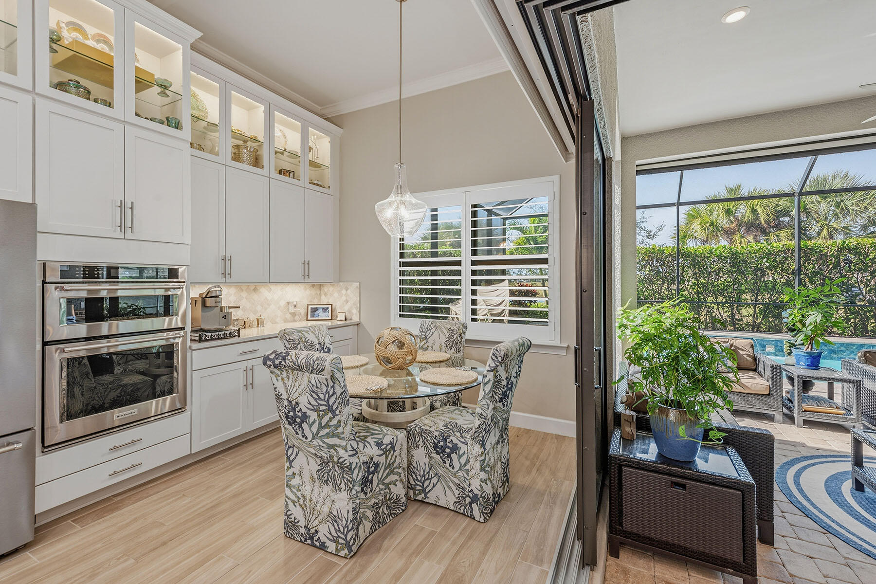 2797 Amaranda Court Naples, FL 34114 - Photo 12 of 50 a dining room with furniture a fireplace and wooden floor