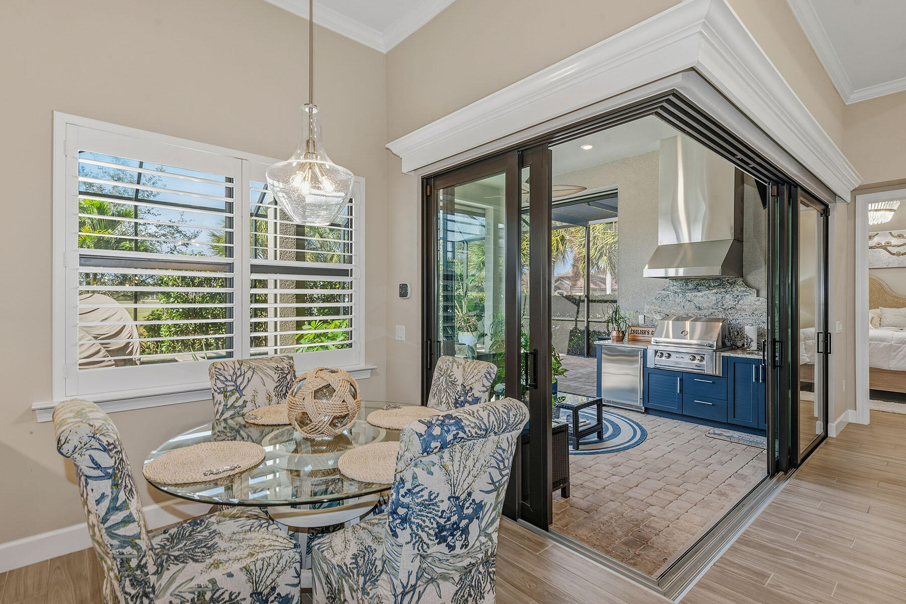 2797 Amaranda Court Naples, FL 34114 - Photo 13 of 50 a dining room with furniture a chandelier and wooden floor