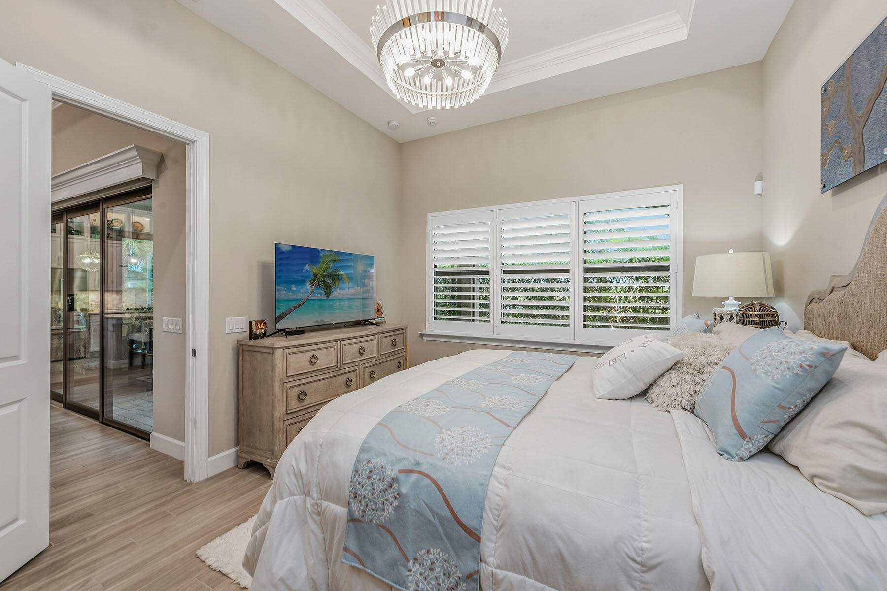 2797 Amaranda Court Naples, FL 34114 - Photo 16 of 50 a bedroom with a bed and a television in it