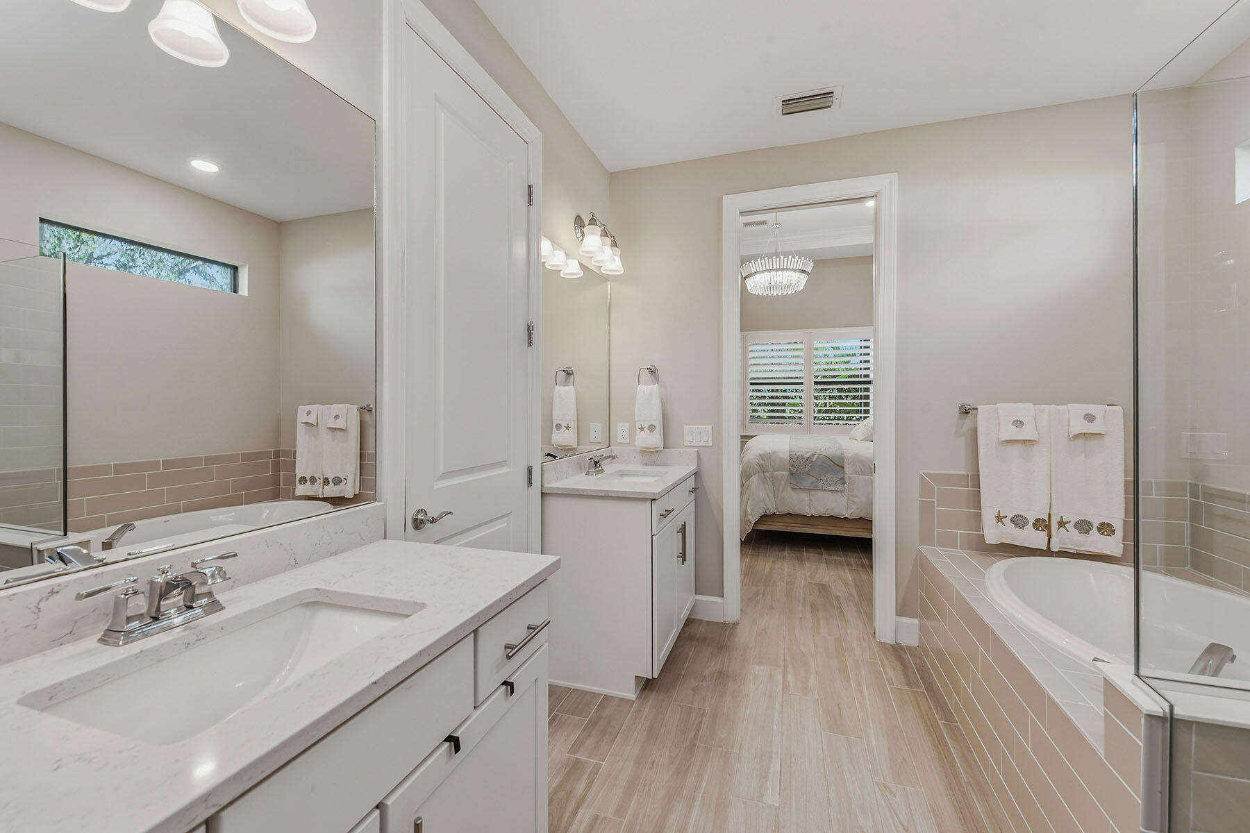 2797 Amaranda Court Naples, FL 34114 - Photo 17 of 50 a en suite spacious bathroom with a tub double vanity and mirrors