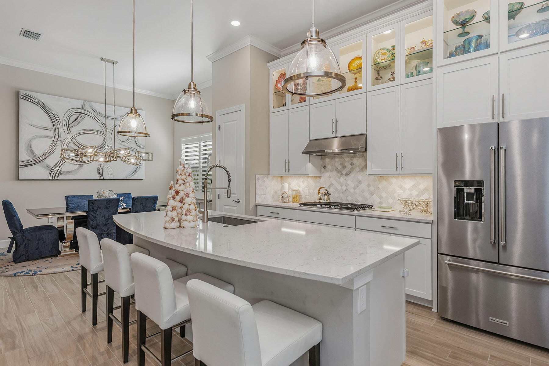 2797 Amaranda Court Naples, FL 34114 - Photo 10 of 50 a kitchen with stainless steel appliances granite countertop a kitchen island a stove a table and chairs in it