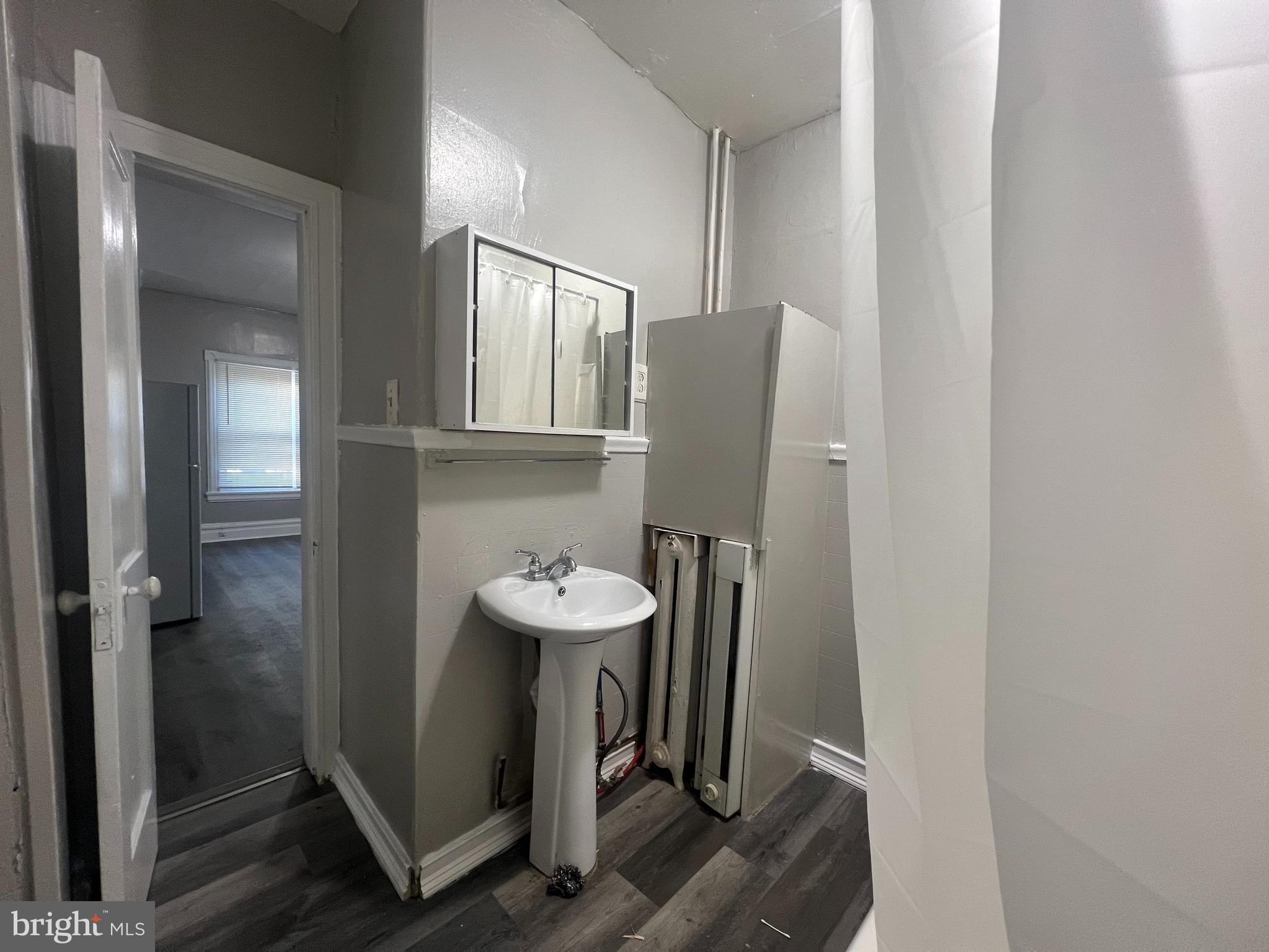 4637 Leiper Street, Unit 4 Philadelphia, PA 19124 - Photo 4 of 4 a bathroom with a sink and mirror