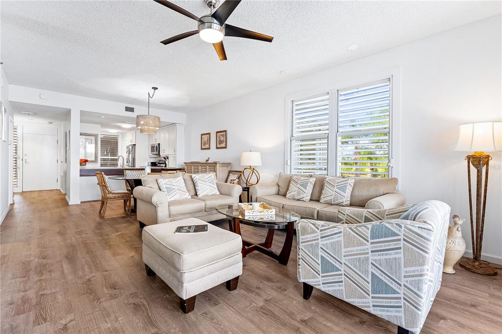 615 Dream Island Road, Unit 202 Longboat Key, FL 34228 - Photo 13 of 66 a living room with furniture and a large window