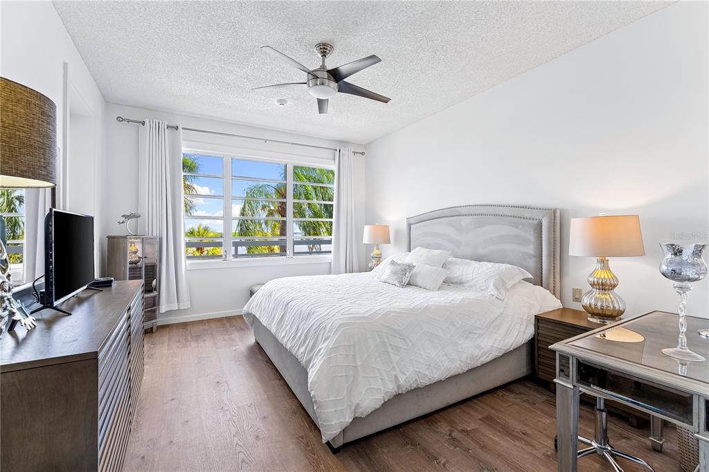 615 Dream Island Road, Unit 202 Longboat Key, FL 34228 - Photo 20 of 66 a bedroom with a bed and a flat screen tv