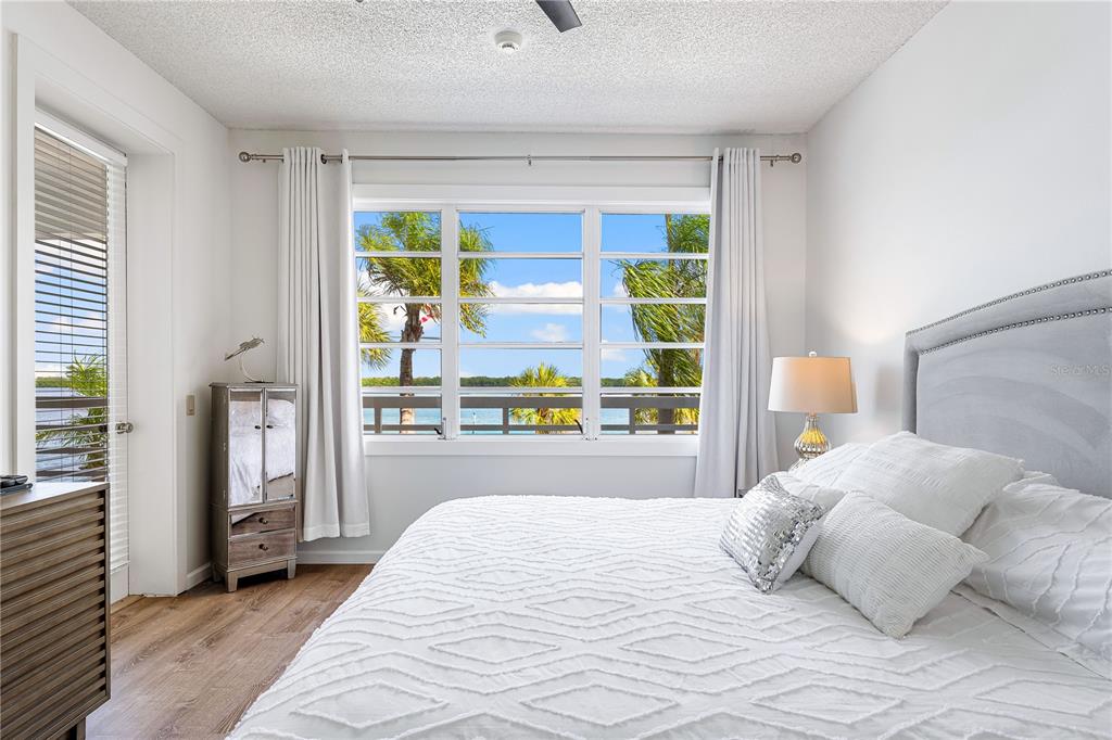 615 Dream Island Road, Unit 202 Longboat Key, FL 34228 - Photo 21 of 66 a bedroom with a large bed and a large window