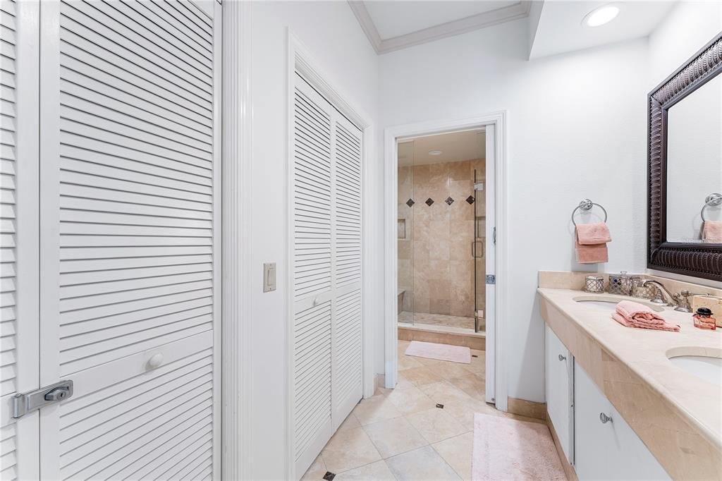 615 Dream Island Road, Unit 202 Longboat Key, FL 34228 - Photo 25 of 66 a bathroom with a sink a toilet and shower