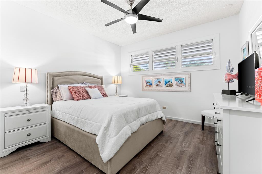 615 Dream Island Road, Unit 202 Longboat Key, FL 34228 - Photo 27 of 66 a bedroom with a bed and a flat screen tv