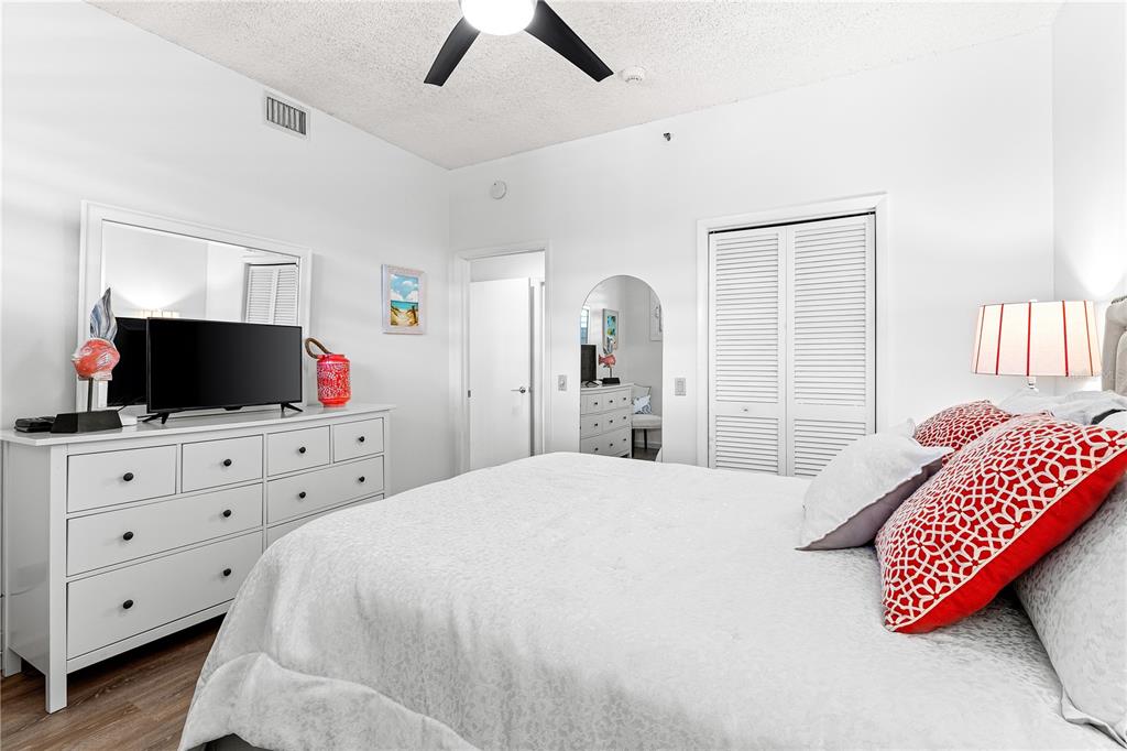 615 Dream Island Road, Unit 202 Longboat Key, FL 34228 - Photo 29 of 66 a bedroom with a bed and wooden floor