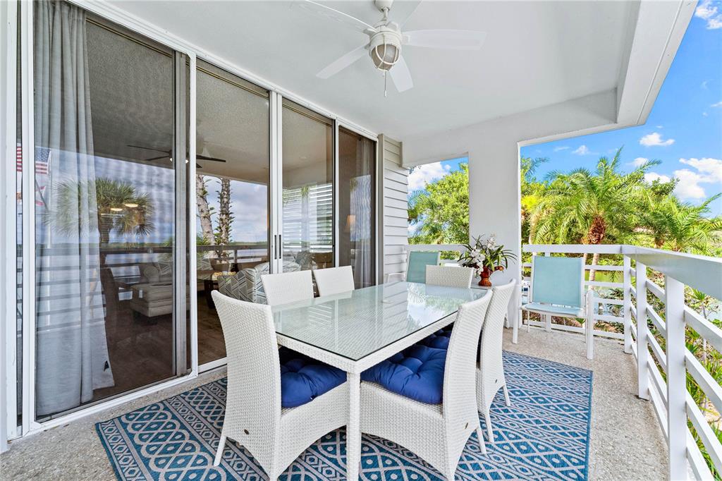 615 Dream Island Road, Unit 202 Longboat Key, FL 34228 - Photo 31 of 66 a view of a dining room with furniture window and wooden floor