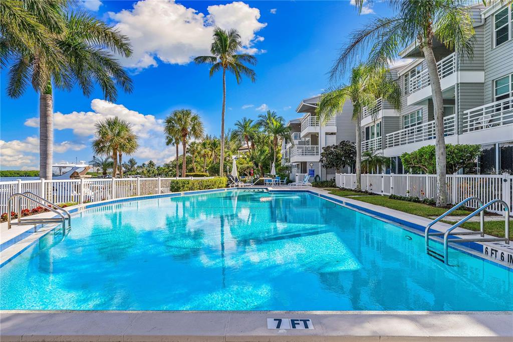 615 Dream Island Road, Unit 202 Longboat Key, FL 34228 - Photo 39 of 66 a view of a swimming pool with a patio