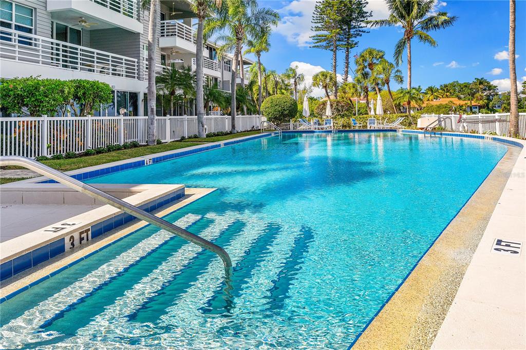 615 Dream Island Road, Unit 202 Longboat Key, FL 34228 - Photo 41 of 66 a swimming pool with outdoor seating and yard