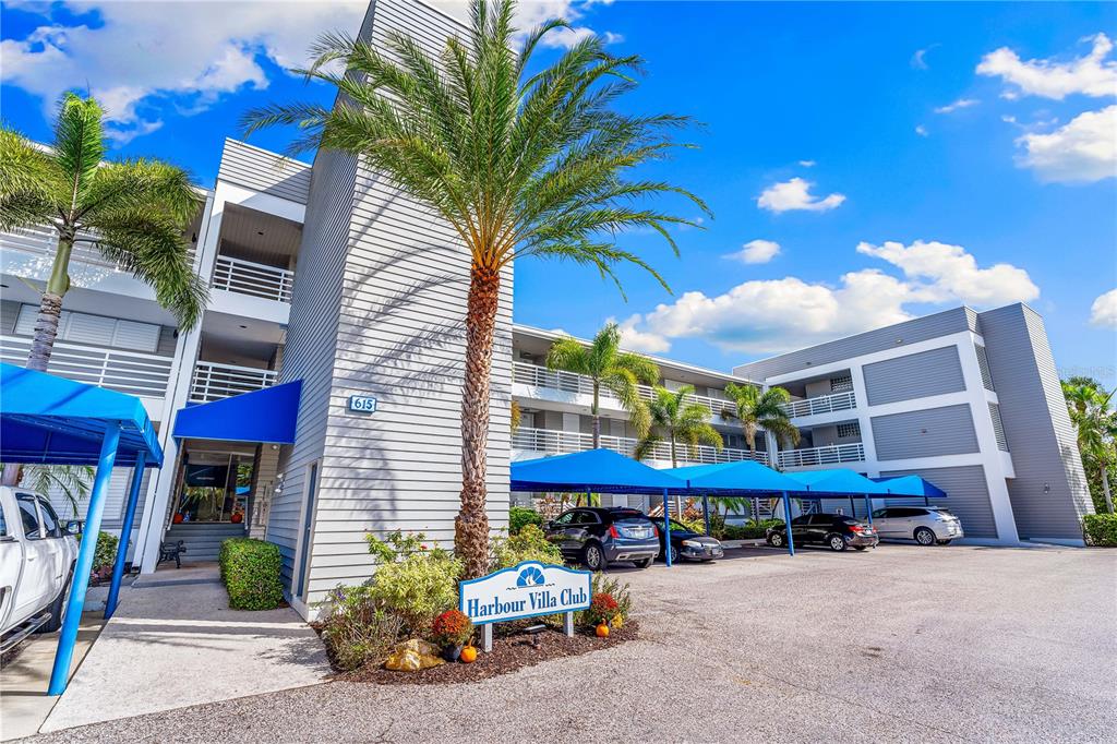 615 Dream Island Road, Unit 202 Longboat Key, FL 34228 - Photo 45 of 66 a view of a chairs and tables in the back yard of the house