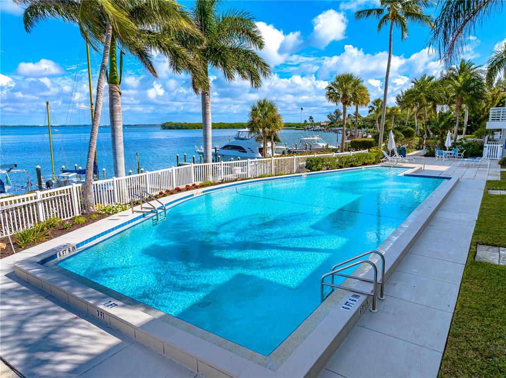 615 Dream Island Road, Unit 202 Longboat Key, FL 34228 - Photo 55 of 66 a view of swimming pool with chairs