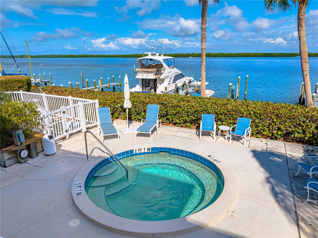 615 Dream Island Road, Unit 202 Longboat Key, FL 34228 - Photo 57 of 66 a view of a swimming pool with a chairs