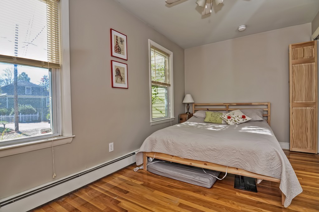 54 Main Street, Unit A Foxboro, MA 02035 - Photo 11 of 21 a bedroom with a bed and window
