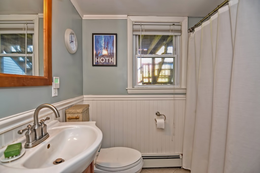 54 Main Street, Unit A Foxboro, MA 02035 - Photo 13 of 21 a bathroom with a sink toilet and window