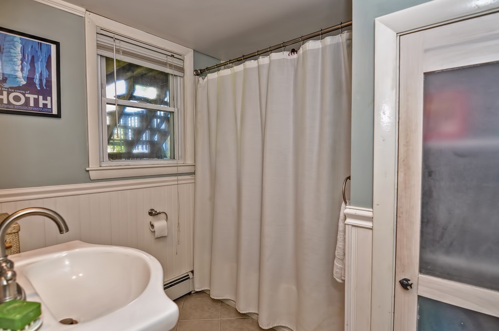 54 Main Street, Unit A Foxboro, MA 02035 - Photo 14 of 21 a bathroom with a sink and a mirror