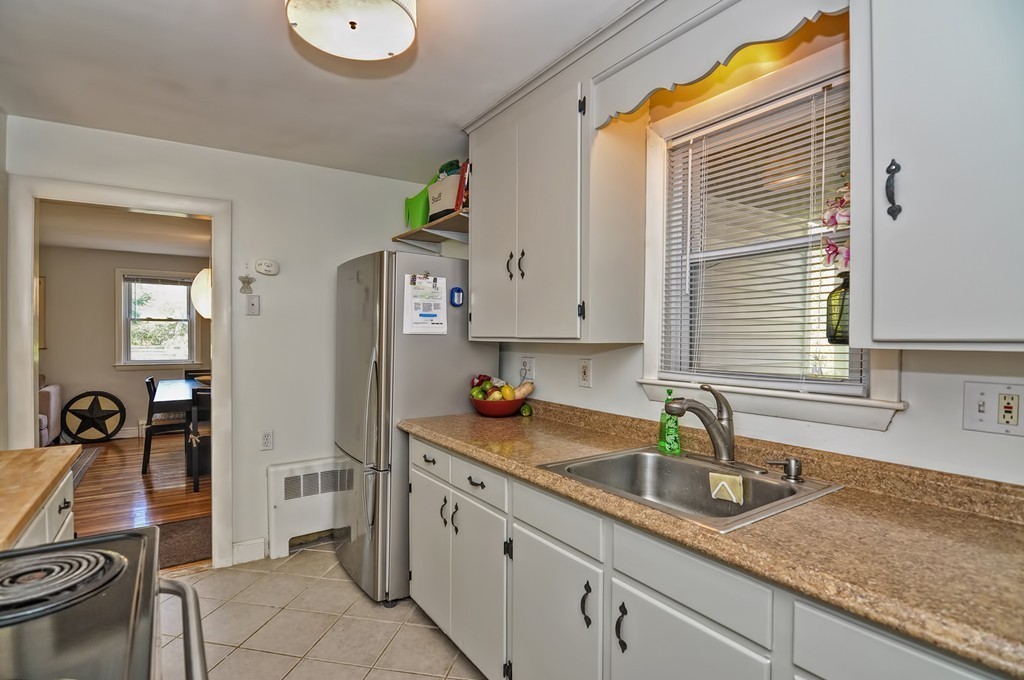 54 Main Street, Unit A Foxboro, MA 02035 - Photo 3 of 21 a kitchen with a sink and cabinets