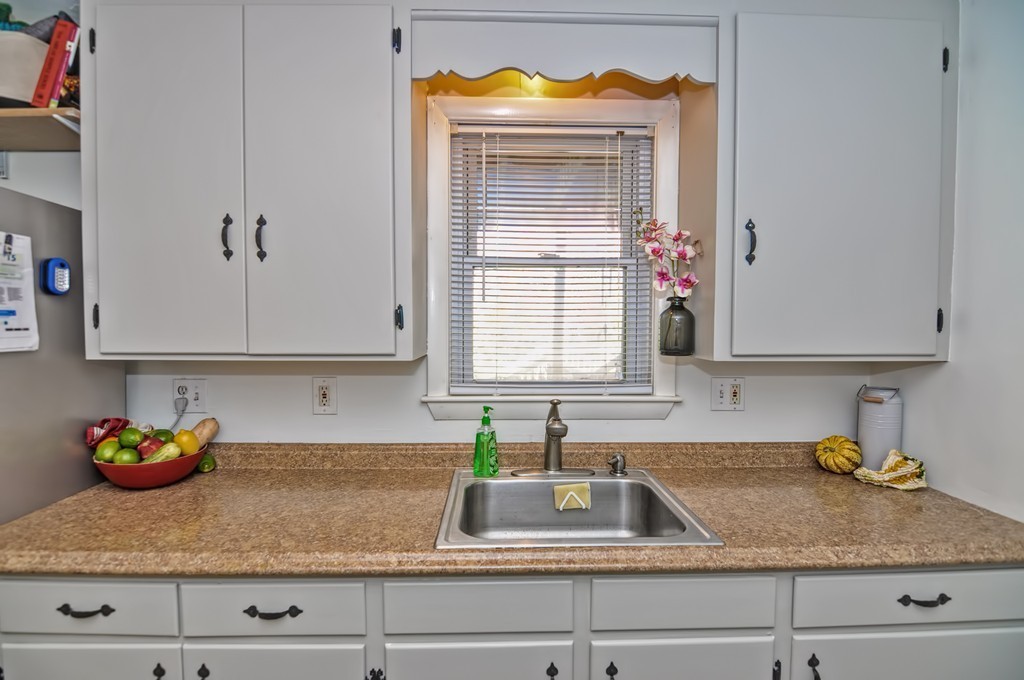54 Main Street, Unit A Foxboro, MA 02035 - Photo 4 of 21 a kitchen with granite countertop white cabinets and a potted plant