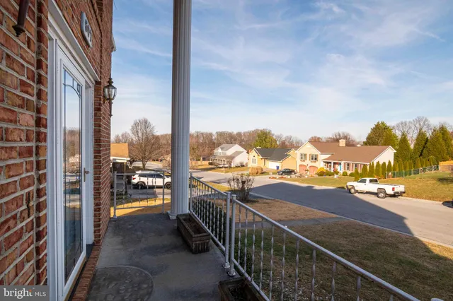 en empty room with windows and chandelier fan