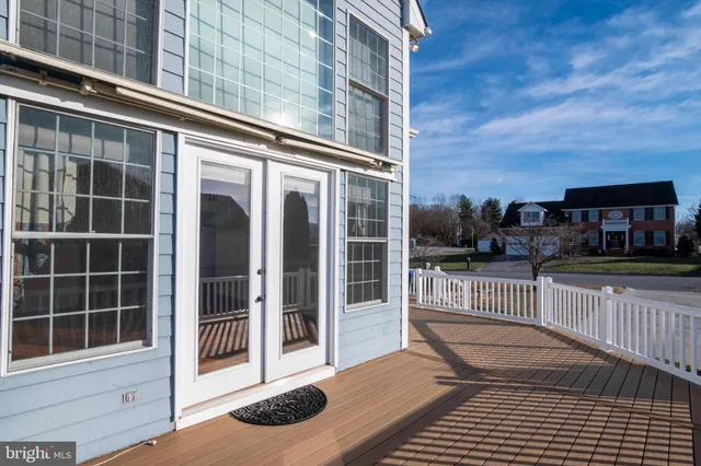 an empty room with windows and ceiling fan